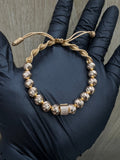 MANILLA TEJIDA CON BALINES DE ORO ROSA 18K